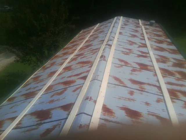 Rusted metal roof panels with new wood purlins before replacement — Storm Damage Roof Repair in Sopchoppy by Roofing Brothers
